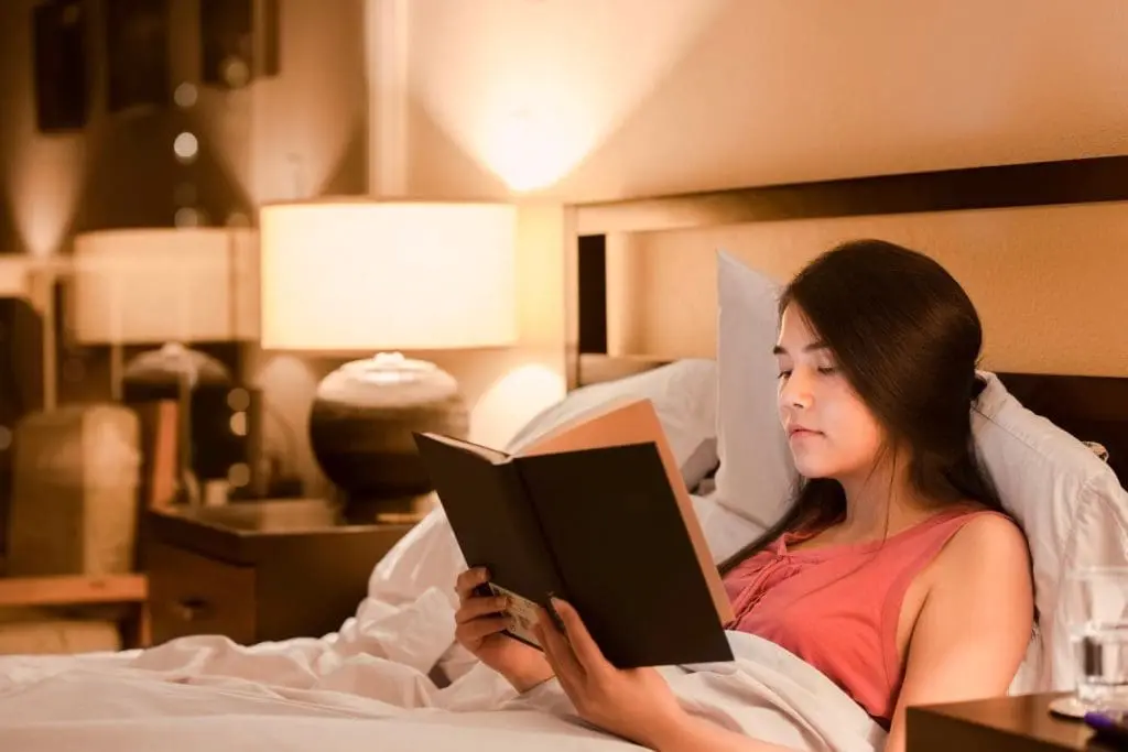 Sleep Anxiety: What Parents Need To Know 1 Teen relaxes to reduce sleep anxiety symptoms.