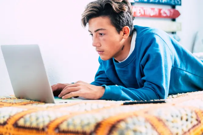 Teen taking ADHD test and then thinking of joining virtual therapy session for ADHD.