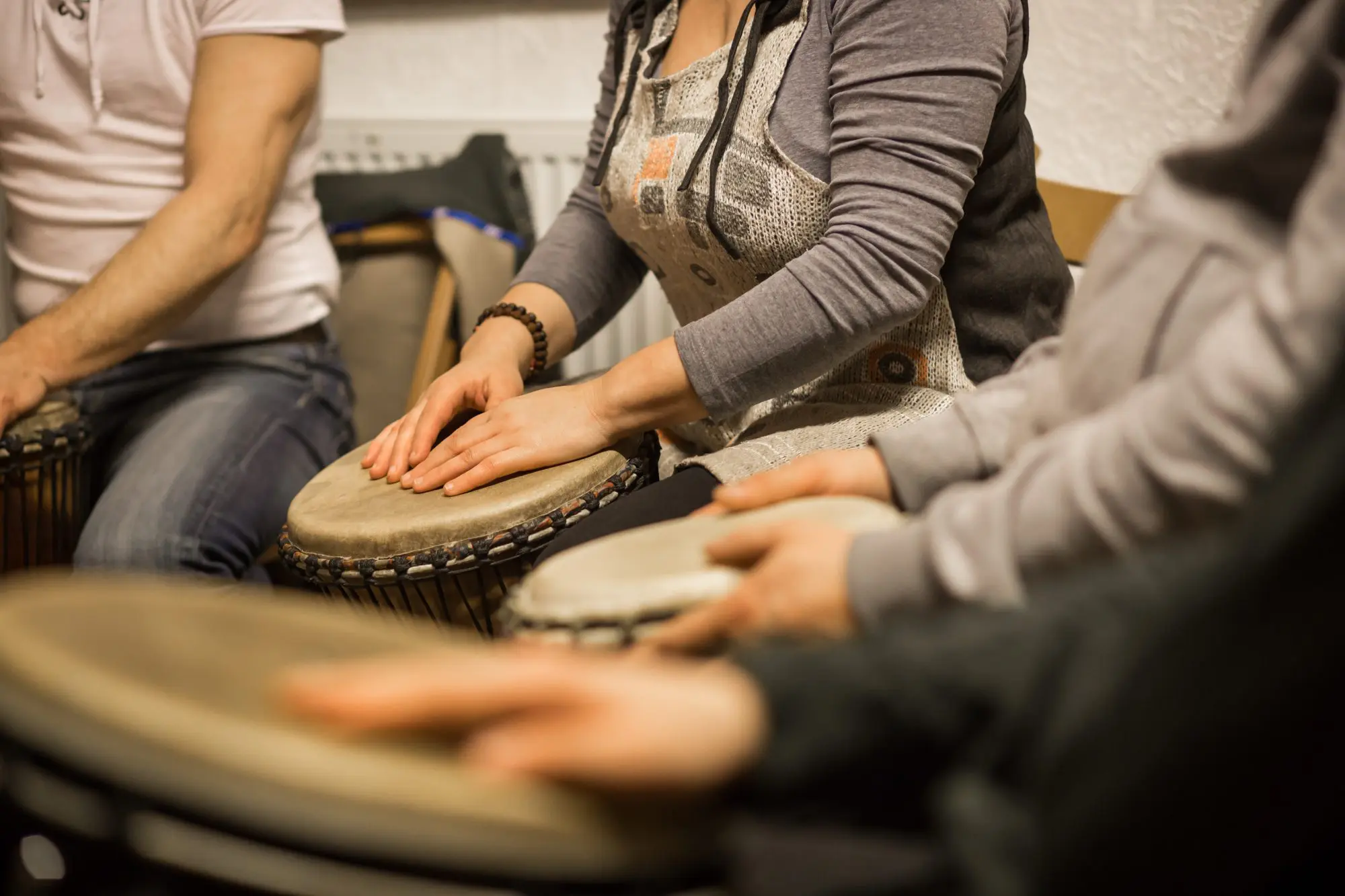 Intensive Outpatient Programs (IOPs) 12 Close up of hands on african drums, drumming for a music therapy