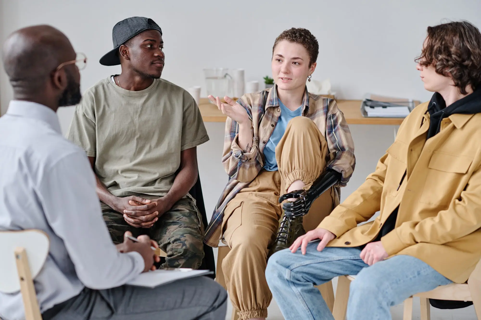 Teens and young adults talking to a therapist in PHP program. Teens and young adults talking to a therapist in PHP program.