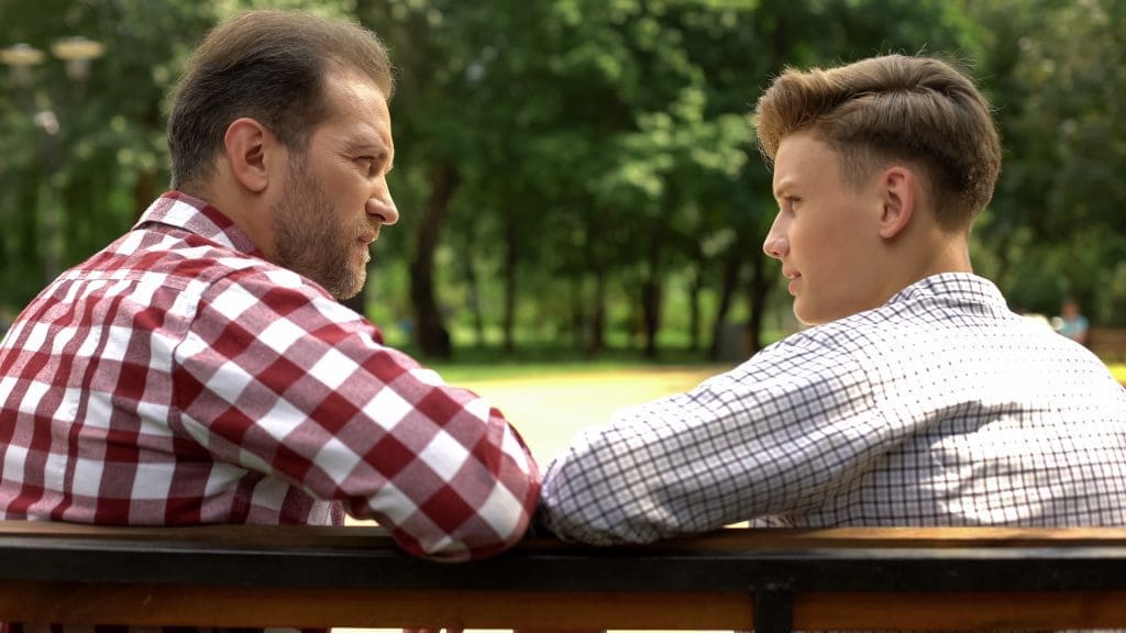 Father and teen son discuss suicide prevention techniques they can use.