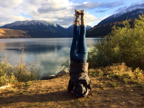 Teen practices yoga as a therapeutic activity on the lake during wilderness therapy