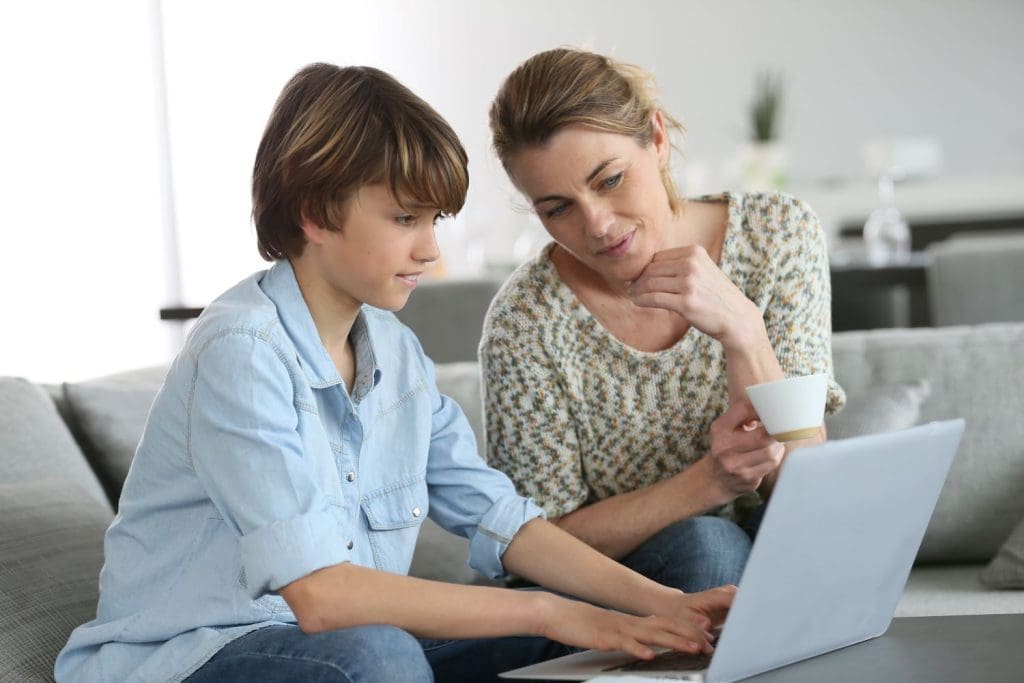 Mother and son participate in online counseling for teens.