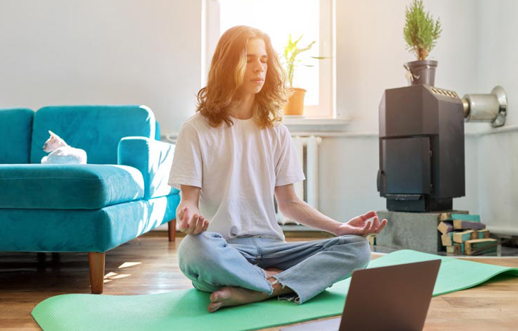 Adolescent participates in yoga to help depression in virtual IOP.