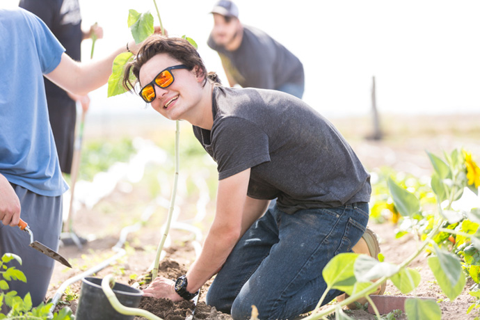 Young adult enjoys gardening at residential treatment center to help anxiety and depression.