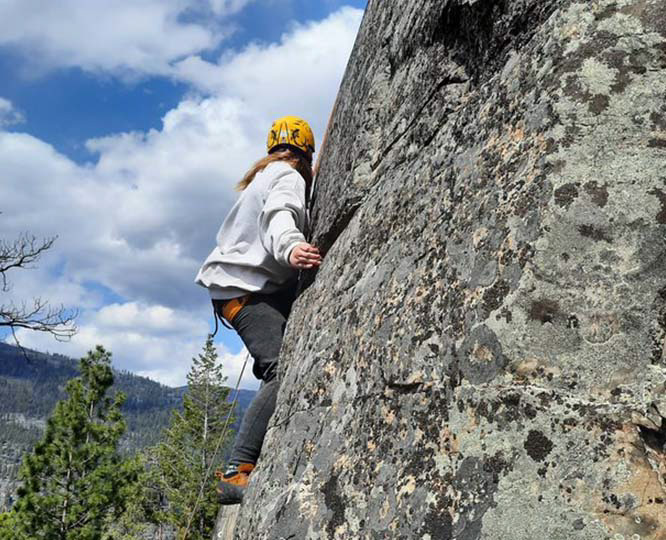 Adolescent student rock climbing in Eureka, Montana boarding school.