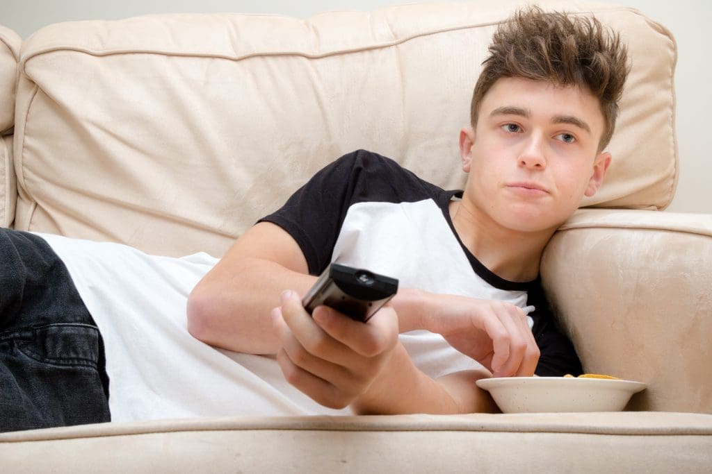 Teen struggling with failure to launch syndrome watches TV at parents’ house.