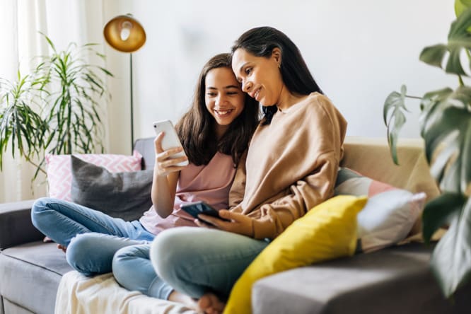 Teen girl and mother look at and talk about the different mental health and substance abuse programs at Embark Behavioral Health.