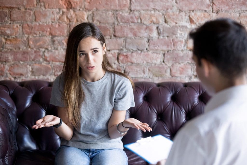 Adolescent struggling with eating disorder talks to therapist.