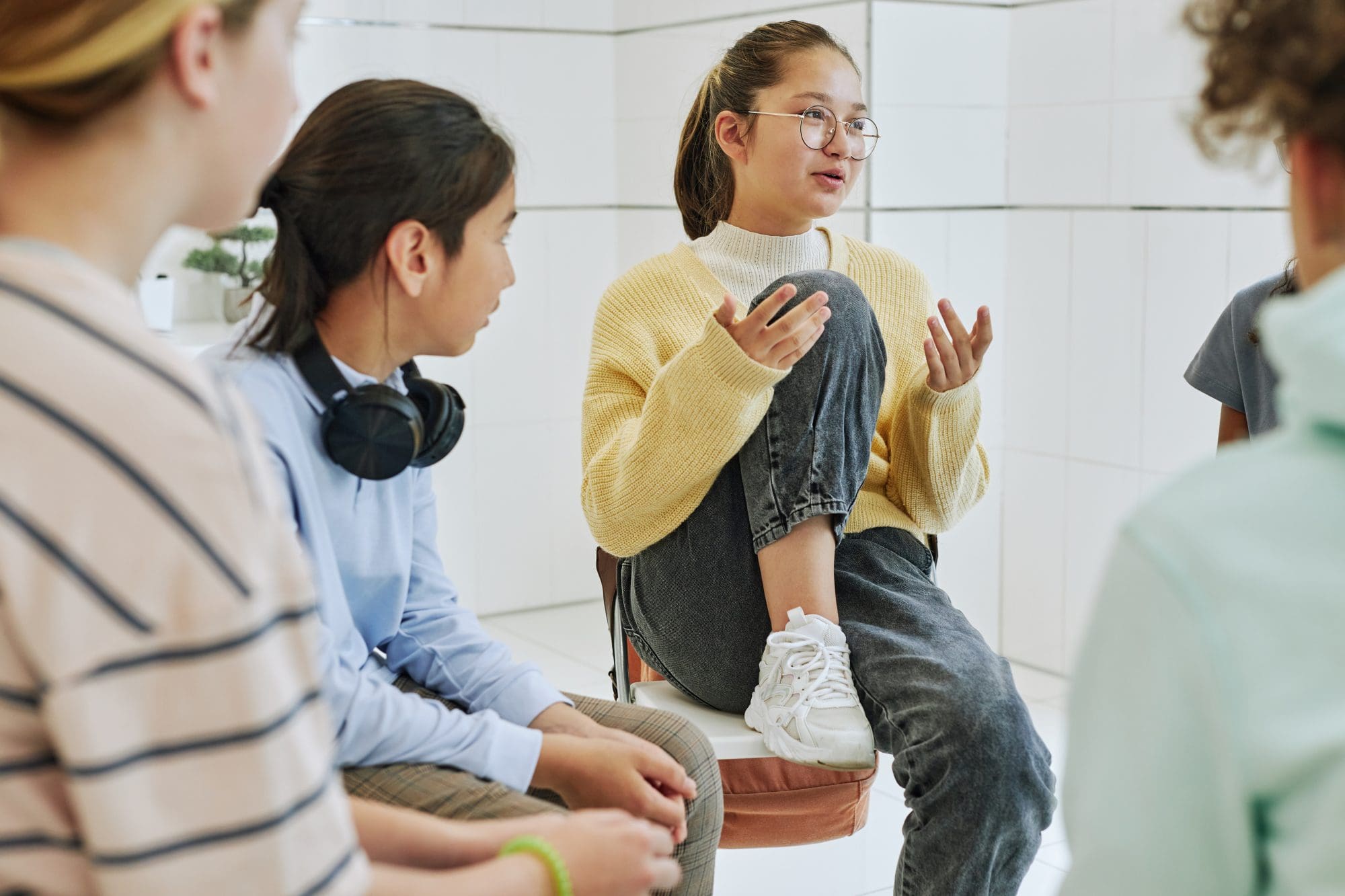Adolescents, teens, and young adults in group therapy session during outpatient treatment.