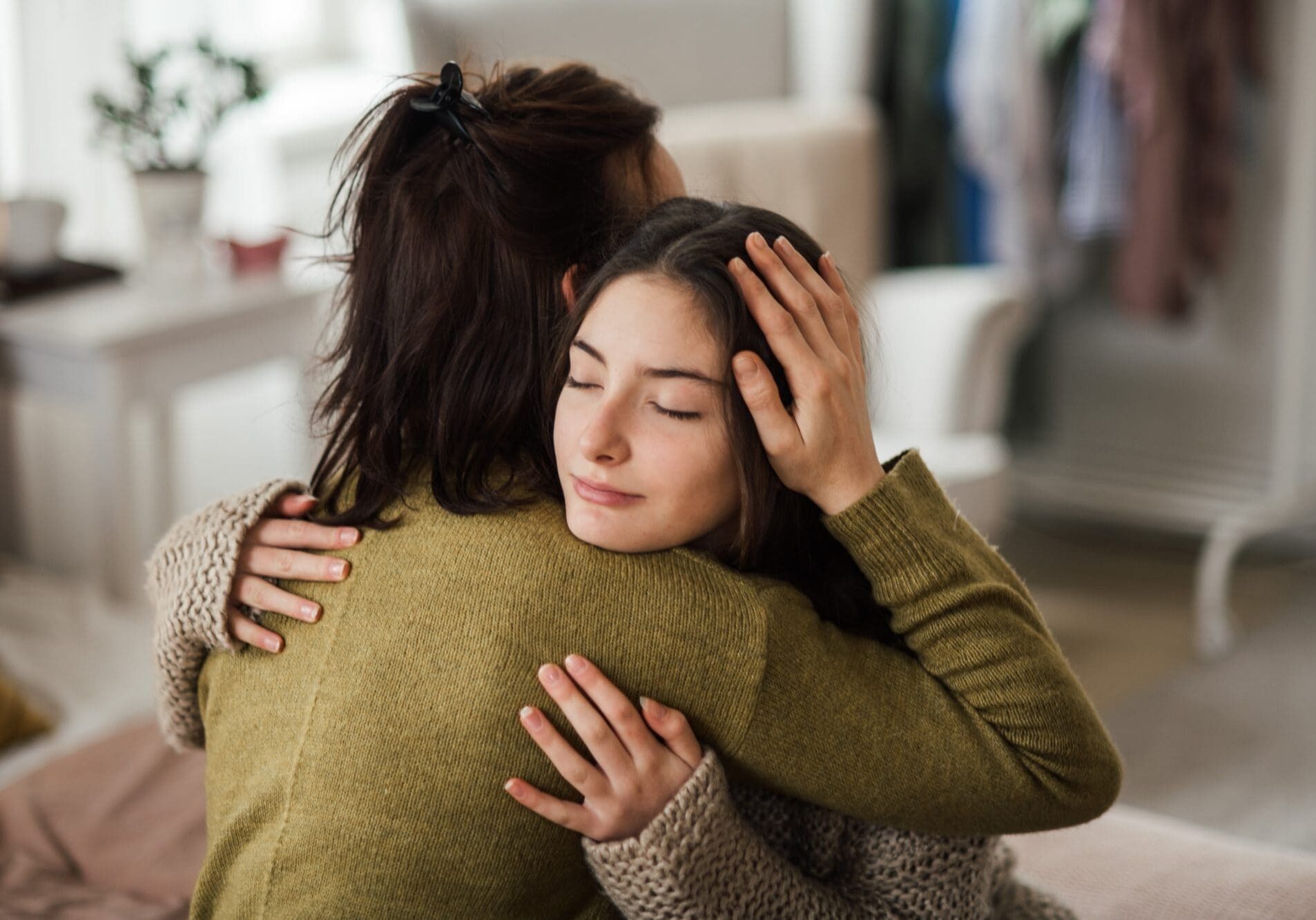 Mother and teen embrace after progress at a residential treatment center for adolescents at Embark Behavioral Health.
